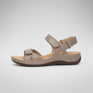 Beige sandal with a strap on a light gray background