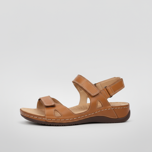 Brown sandal with strap design on a light gray background