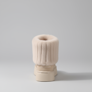 Beige boot with fluffy top on a light gray background