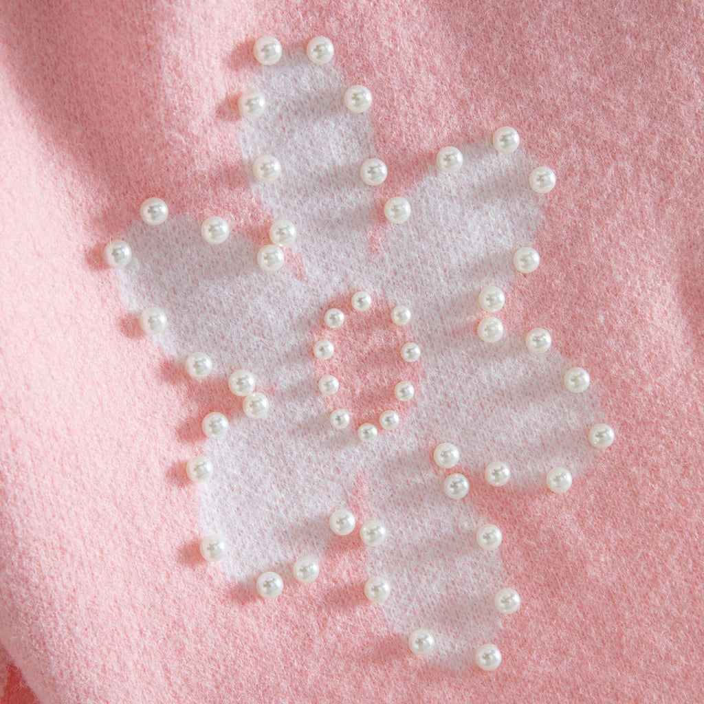 White butterfly with pearl embellishments on a pink background