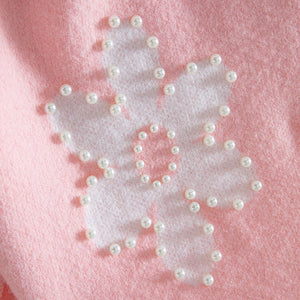 White butterfly with pearl embellishments on a pink background