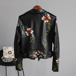 Black leather jacket with floral embroidery on a gray background