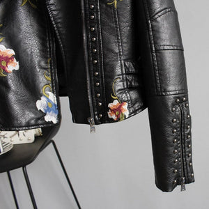 Black leather jacket with floral embroidery on a gray background