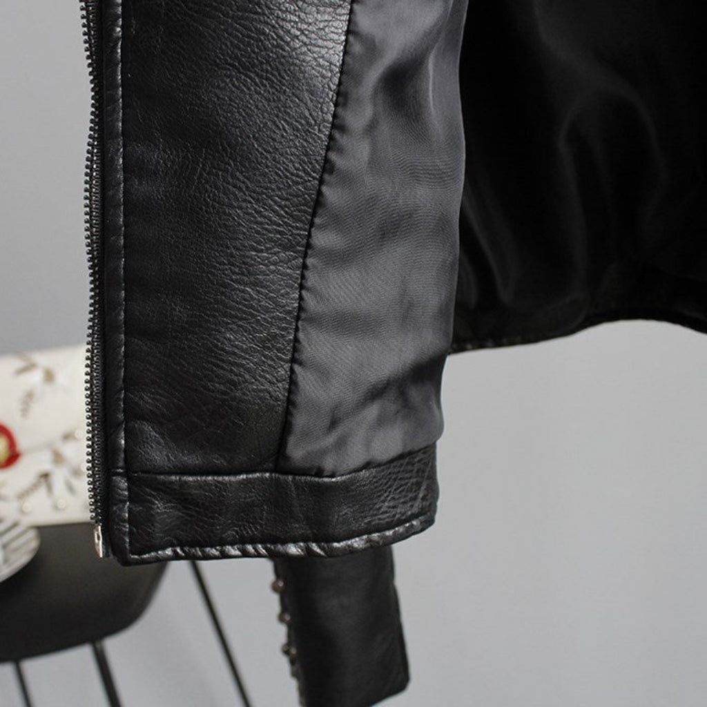 Close-up of a black leather jacket with a blurred background