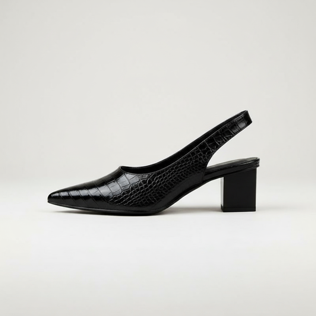Black crocodile-patterned slingback shoe on a light gray background