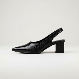 Black crocodile-patterned slingback shoe on a light gray background