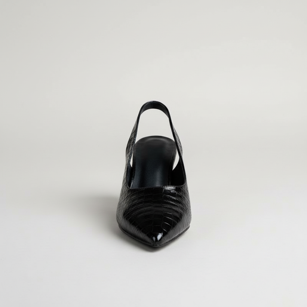 Black high-heeled shoe on a light gray background