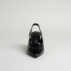 Black high-heeled shoe on a light gray background