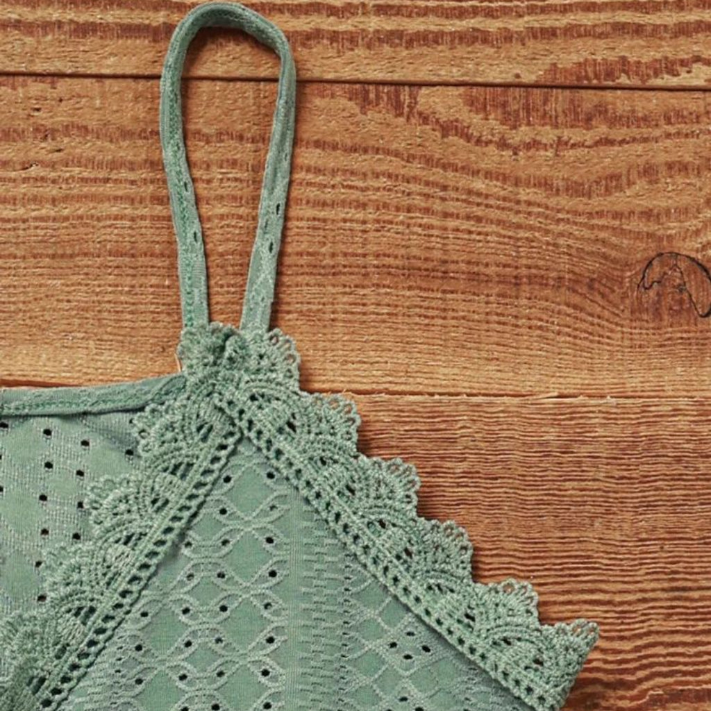 Green lace top on a wooden surface