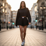 Woman in black outfit walking on a city street