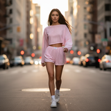 Woman in pink outfit walking on a city street with blurred background