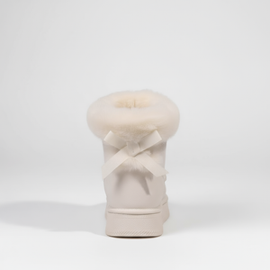 Beige makeup brush with a fluffy top on a white background