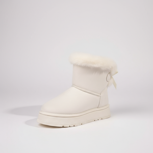 White winter boot with fur trim on a light gray background