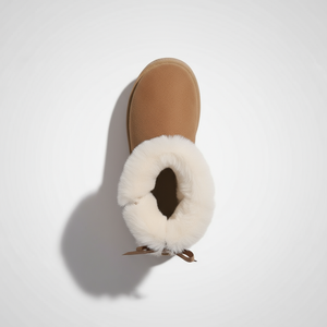 Tan slipper with white fur lining on a light gray background