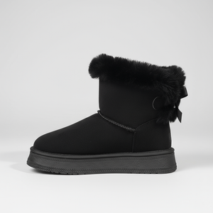 Black snow boot with fur trim and a bow on a light gray background