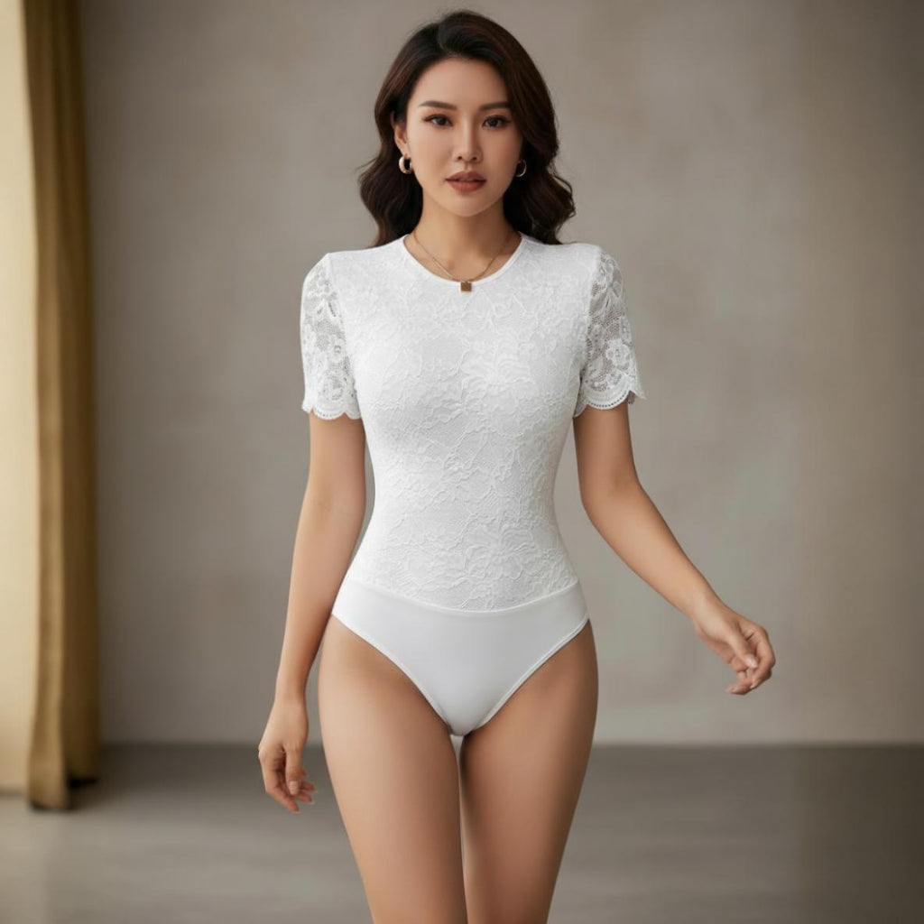 Woman wearing a white lace bodysuit against a neutral background