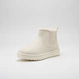 White Chelsea boot on a light gray background