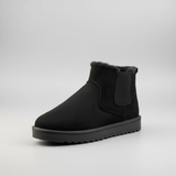 Black ankle boot with a white background