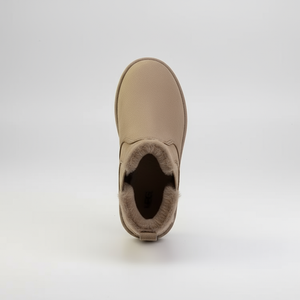 Tan ankle boot with fur lining on a white background