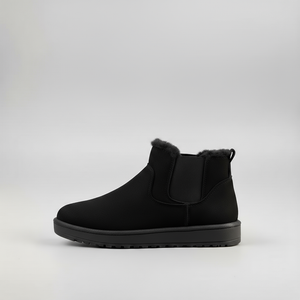 Black ankle boot with fur trim on a light gray background