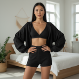 Woman wearing a black athletic outfit in a bright bedroom