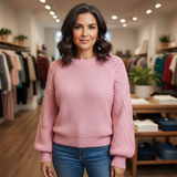 Woman wearing a pink sweater in a clothing store