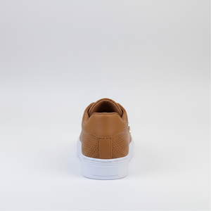 Brown sneaker with white sole on a light gray background