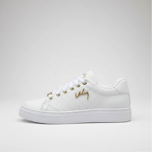 White sneaker with gold accents on a light gray background