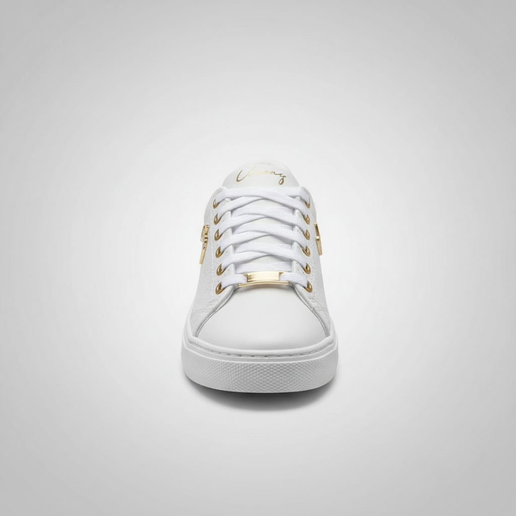 White sneaker with gold accents on a light gray background