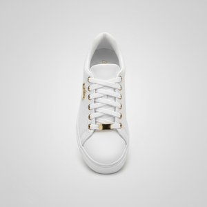 White sneaker with gold accents on a light gray background