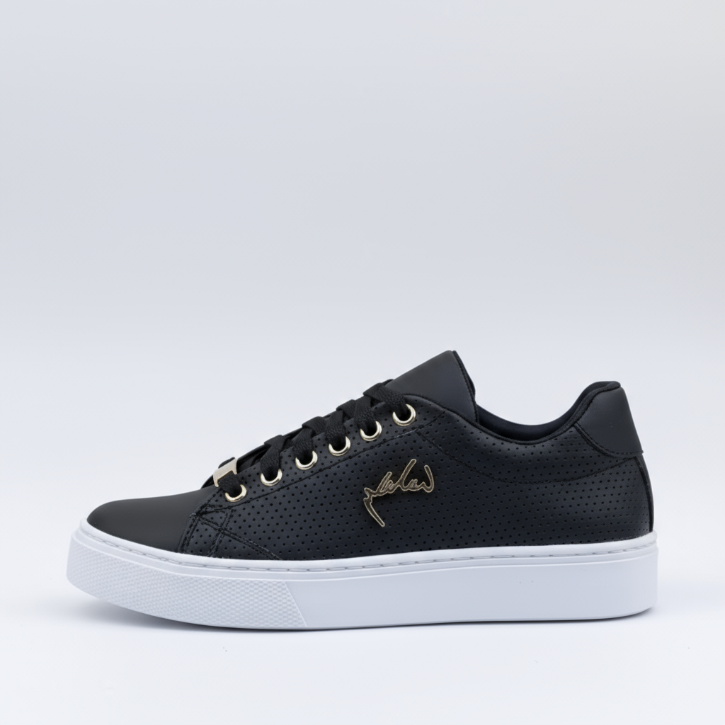 Black sneaker with white sole on a light gray background