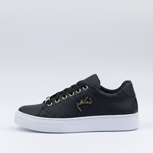 Black sneaker with white sole on a light gray background