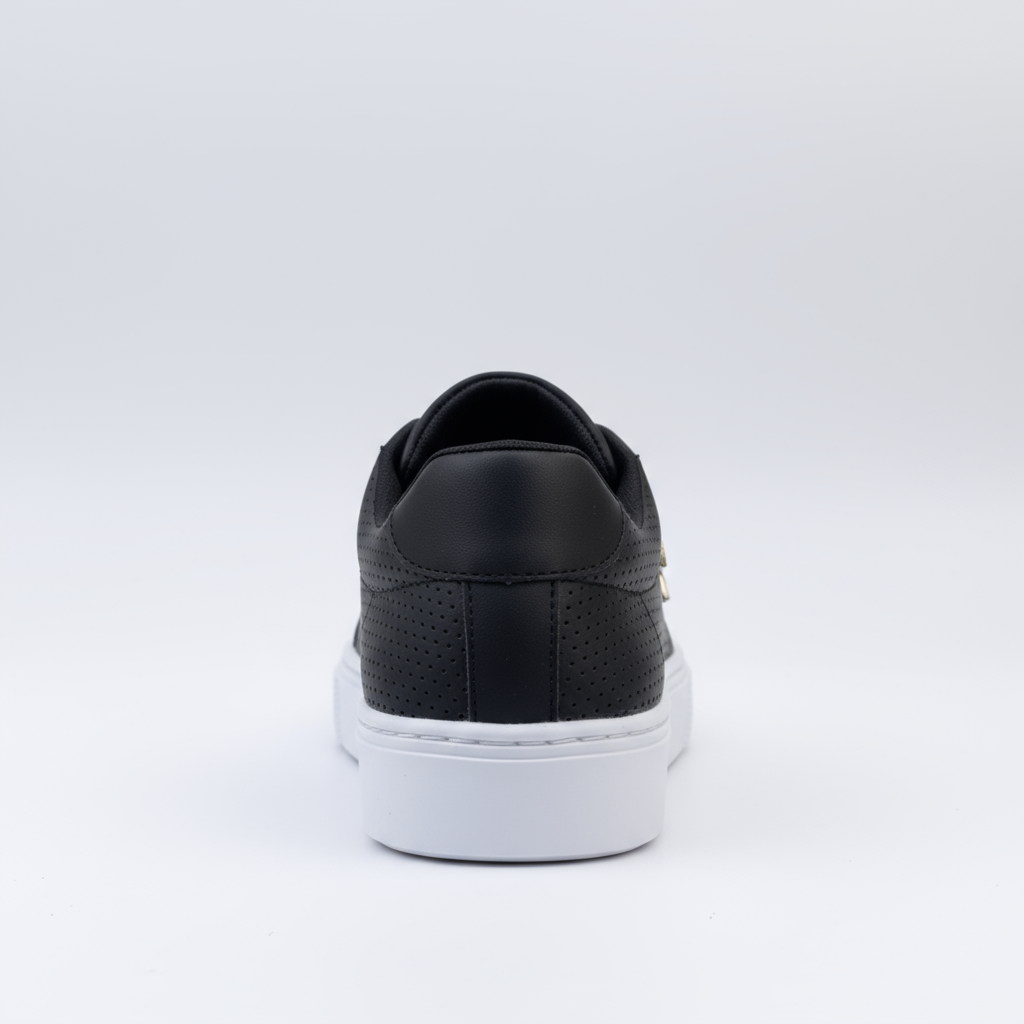 Black sneaker with white sole on a light gray background