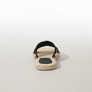 Beige sandal with black strap on a light gray background