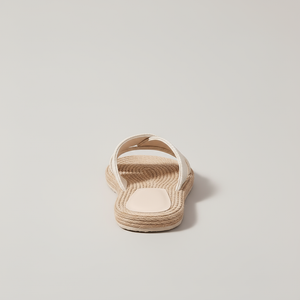 Beige sandal with woven sole on a light gray background