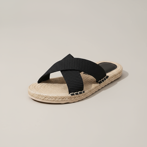 Black sandal with jute sole on a beige background