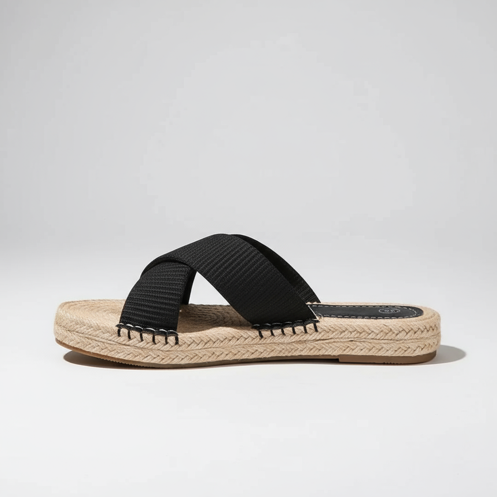 Black sandal with espadrille sole on a light gray background