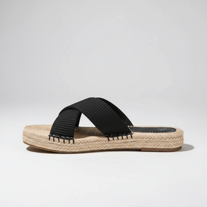 Black sandal with espadrille sole on a light gray background
