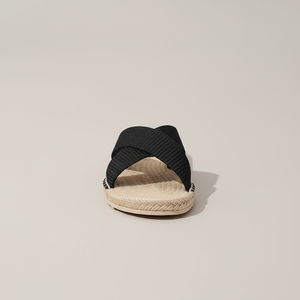 Black espadrille sandal on a beige background
