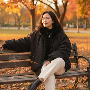 Woman sitting on a bench in a park with autumn leaves