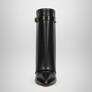Black leather boot on a light gray background