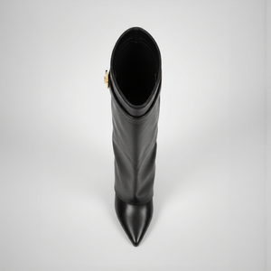Black knee-high boot with a pointed toe on a light gray background
