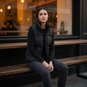 Woman sitting on a wooden bench outside a cafe