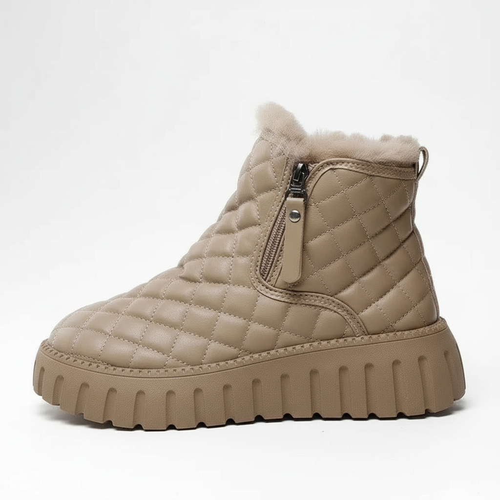 Beige quilted winter boot with a zipper on a white background