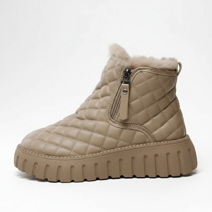 Beige quilted winter boot with a zipper on a white background