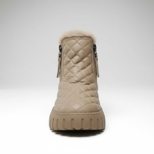 Beige quilted winter boot with fur trim on a white background