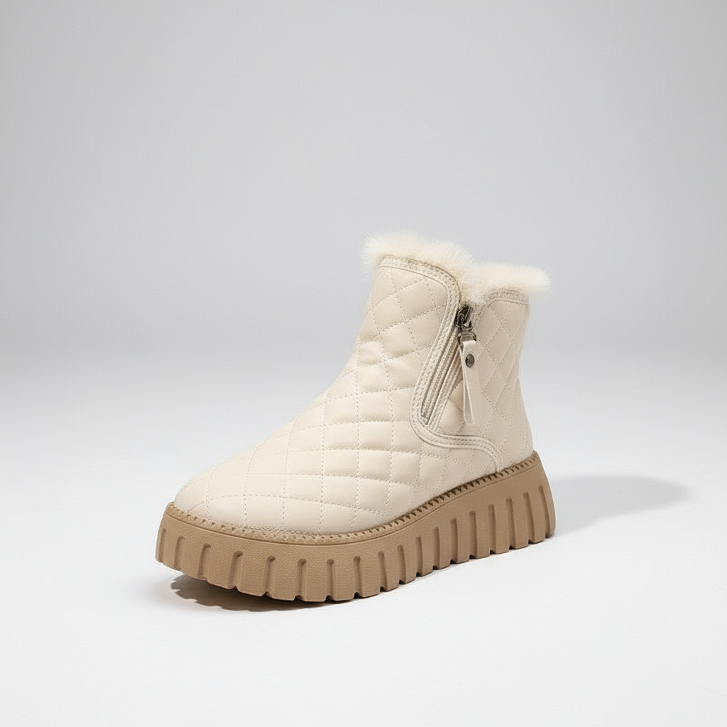 White quilted winter boot with brown sole on a light gray background