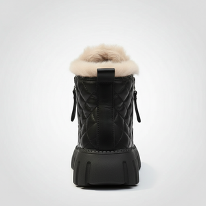 Black quilted winter boot with fur lining on a white background