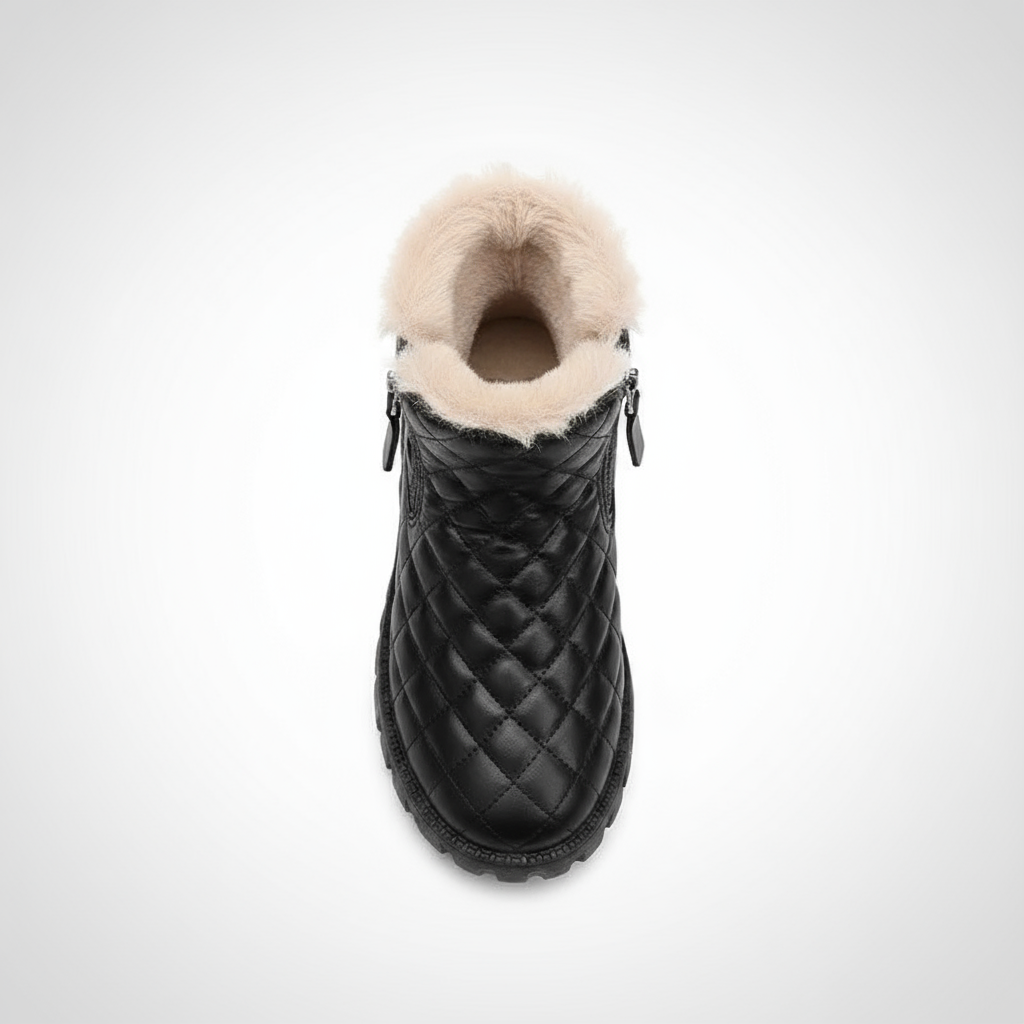 Black quilted ankle boot with fur lining on a white background