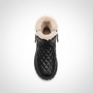 Black quilted ankle boot with fur lining on a white background